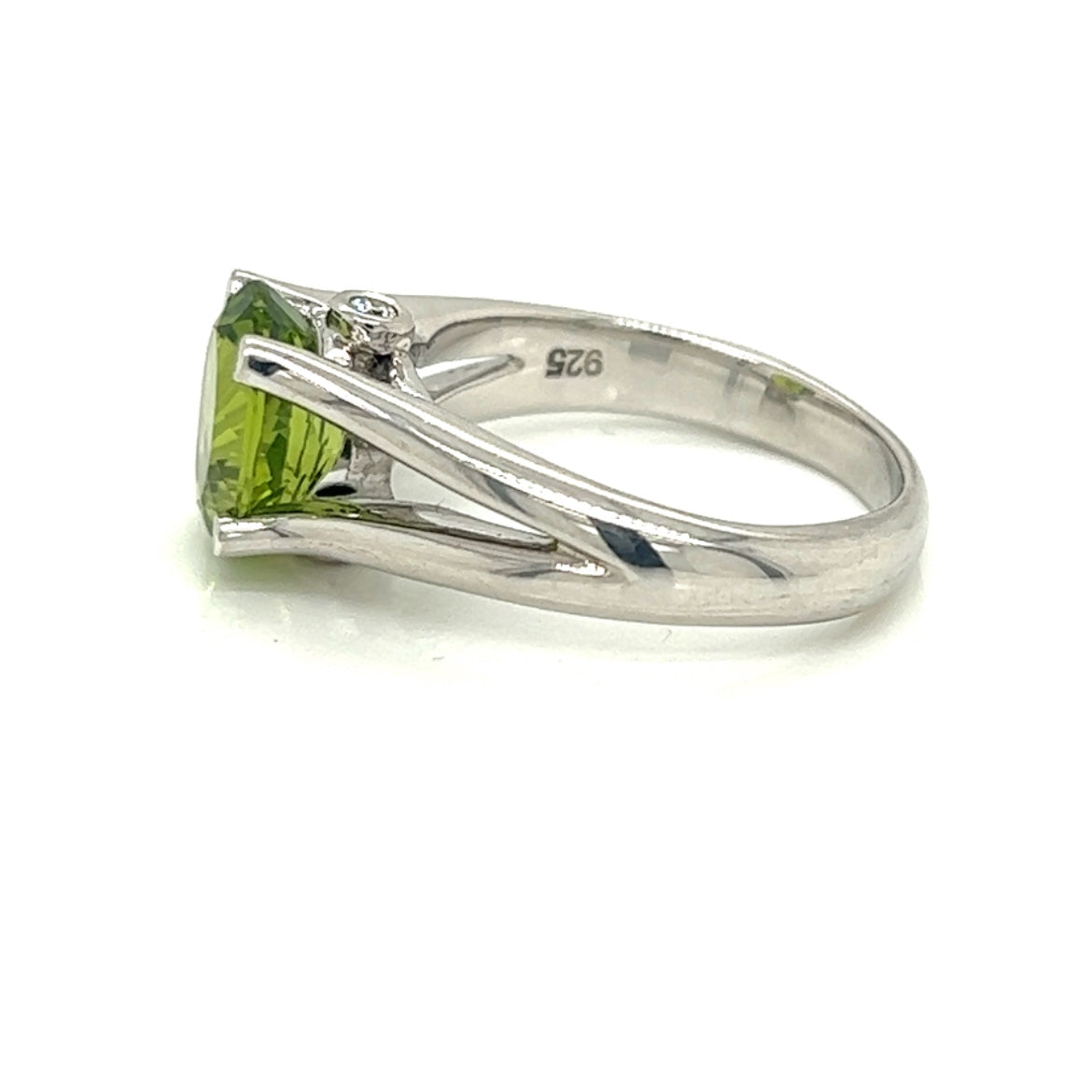 Oval Peridot Gemstone  With Two Bezel Set Diamonds Set On The Side