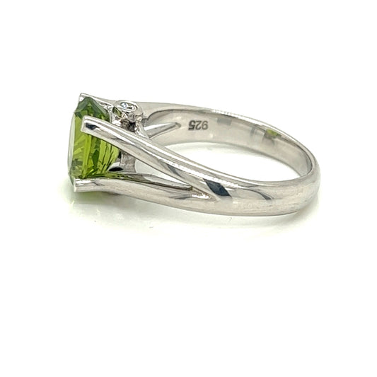 Oval Peridot Gemstone  With Two Bezel Set Diamonds Set On The Side